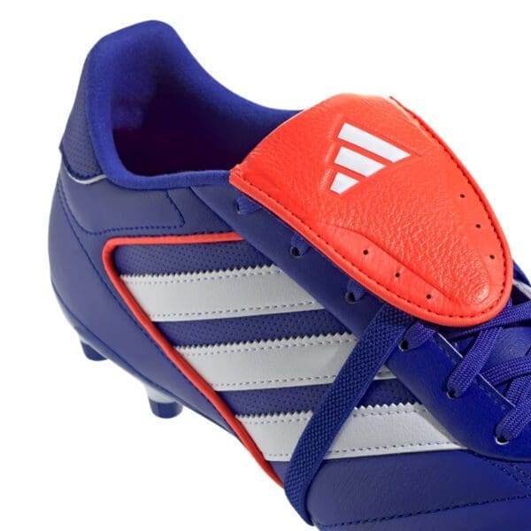 Blue and red Adidas soccer cleats.