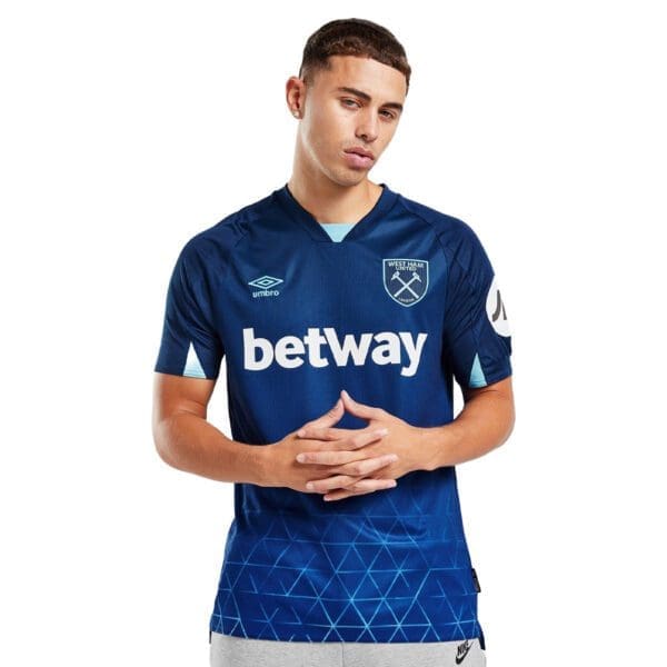 Man wearing West Ham United jersey.