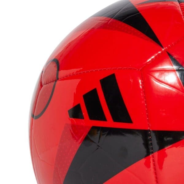 Red and black Adidas soccer ball.