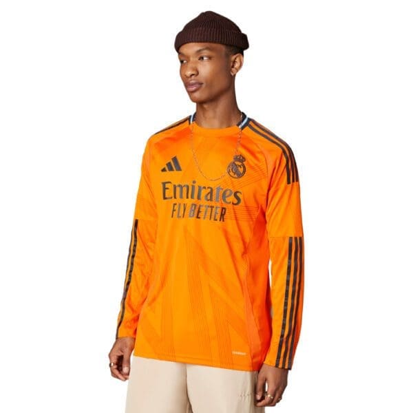 Man wearing orange Real Madrid jersey.