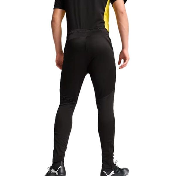 Man wearing black training pants.