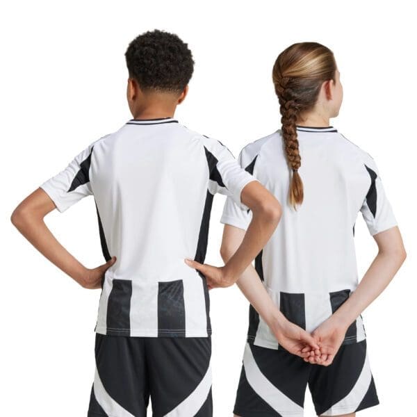 Two kids wearing black and white jerseys.