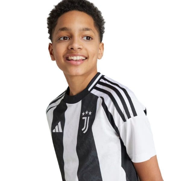 Smiling boy wearing a Juventus jersey.