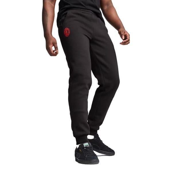 Man wearing black sweatpants with red logo.