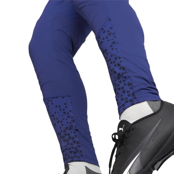 Blue soccer pants with black pattern.