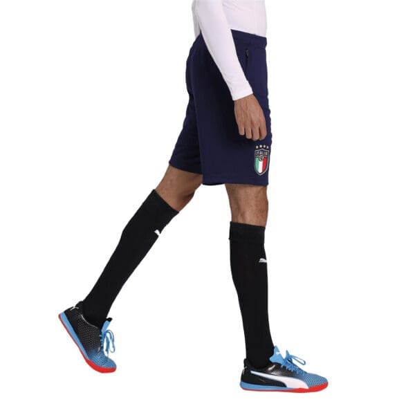 Man wearing Italy soccer shorts and shoes.