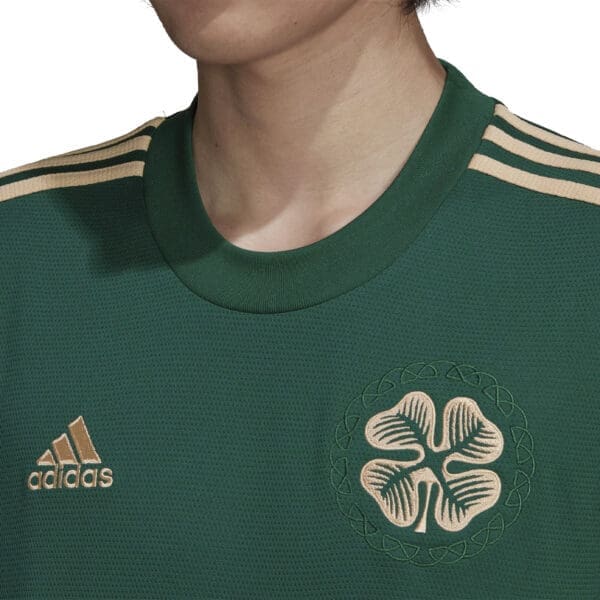 Green Adidas jersey with shamrock logo.