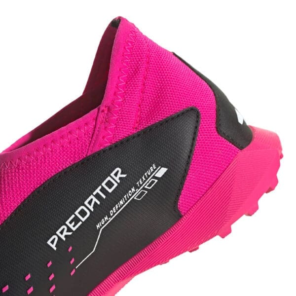 Pink and black Adidas Predator shoe.