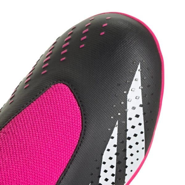 Black and pink soccer shoe detail.