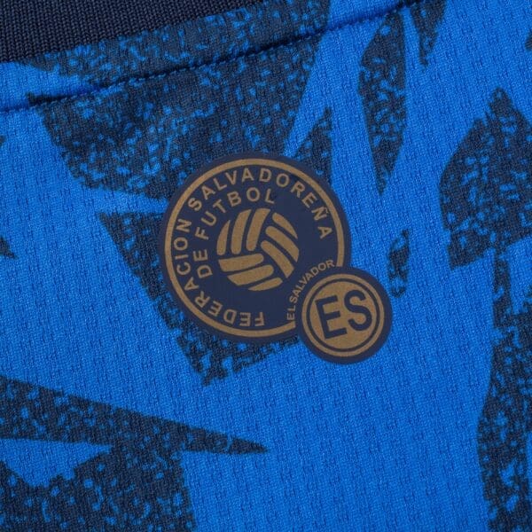 El Salvador football federation logo on blue fabric.