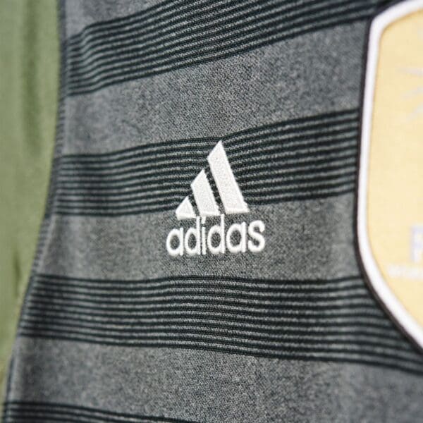 Adidas logo on a striped shirt.