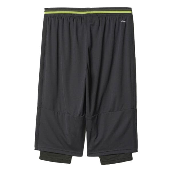 Black Adidas athletic shorts with green trim.