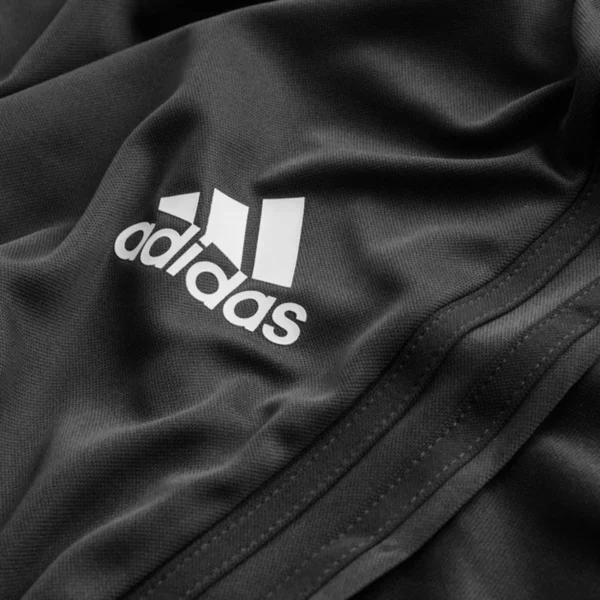 Close-up of a black Adidas shirt.