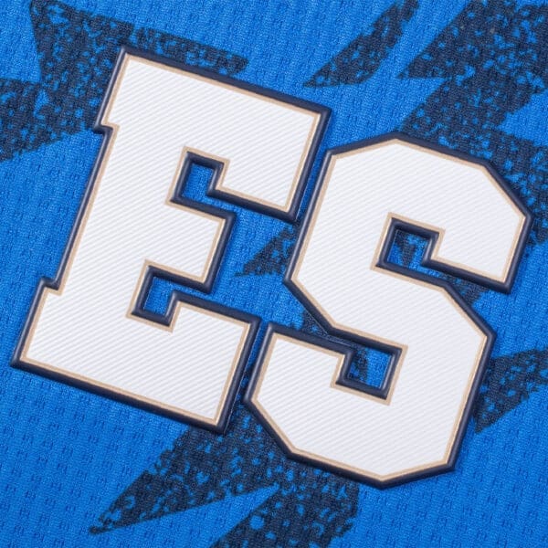 White letters "ES" on blue fabric.