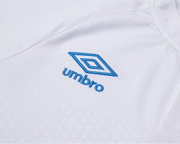 White shirt with blue Umbro logo.