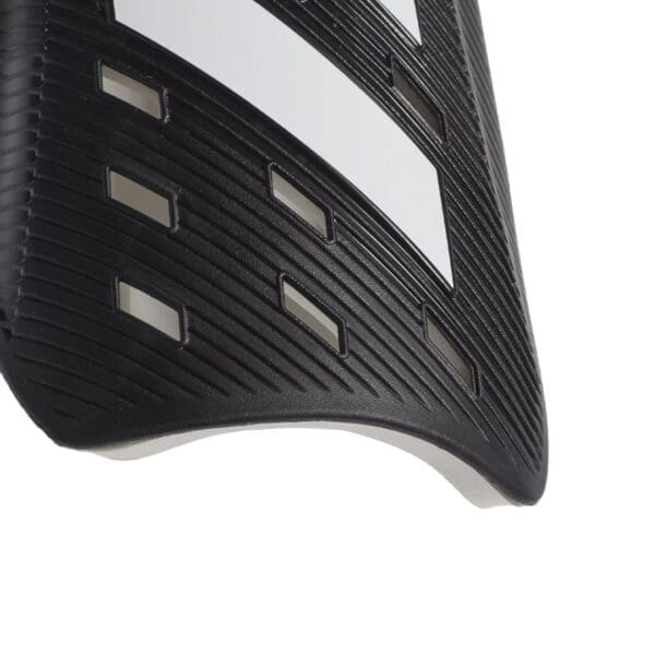 Black and white shin guard with stripes.