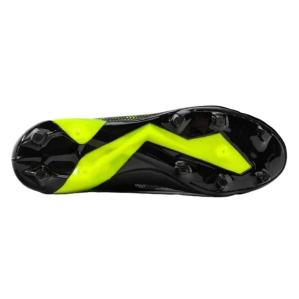 Black and yellow soccer cleats bottom view.