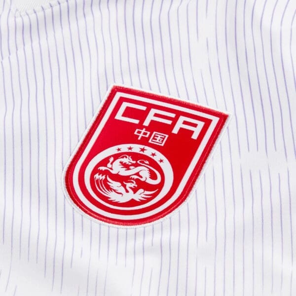 Chinese Football Association crest on white jersey.