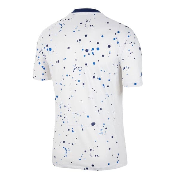 White t-shirt with blue splatter print.