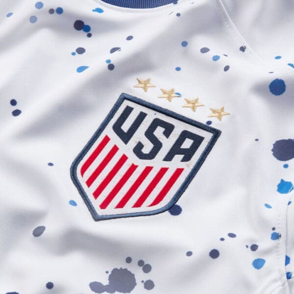 USA soccer jersey with blue splatter design.