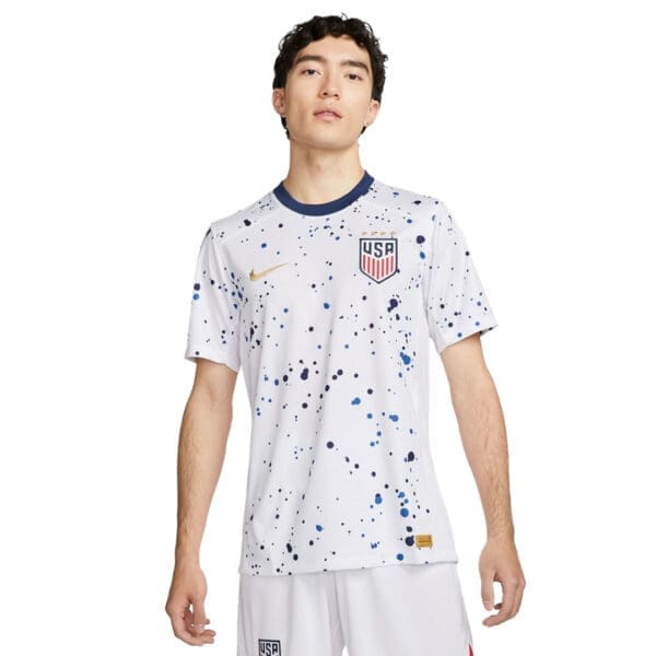 Man wearing white USA soccer jersey.