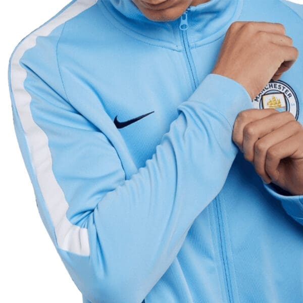 Manchester City Nike jacket with white stripes.