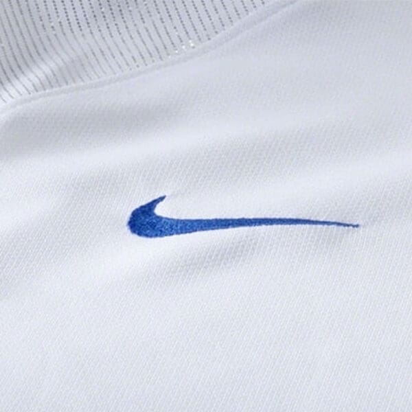 White shirt with blue Nike swoosh logo.