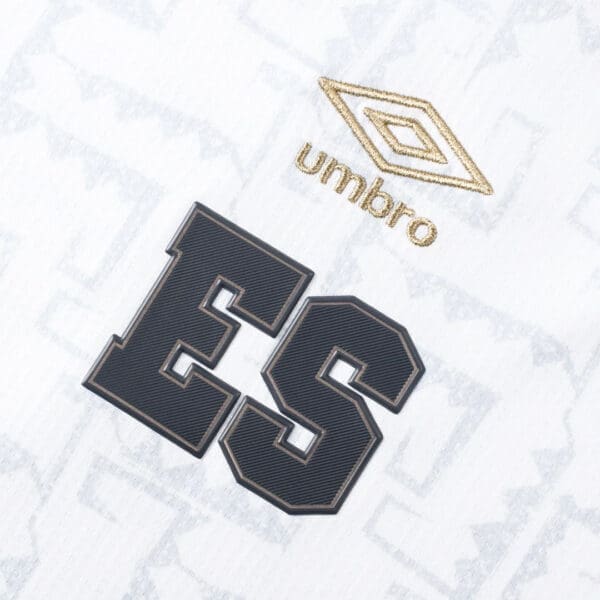 White soccer jersey with "ES" and Umbro logo.