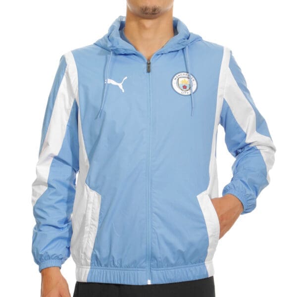 Man wearing a blue and white Manchester City jacket.