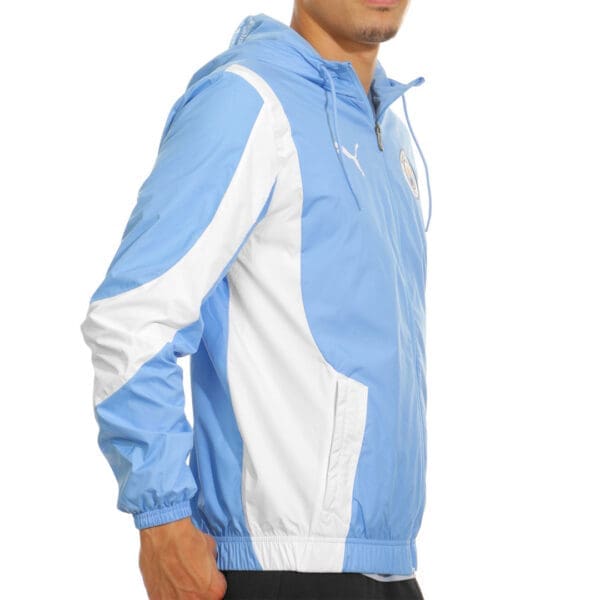 Man wearing a blue and white Puma jacket.