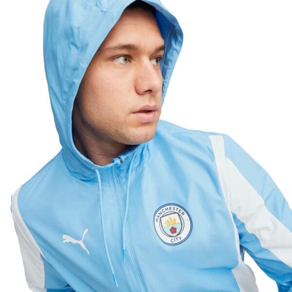 Man wearing a blue Manchester City jacket.