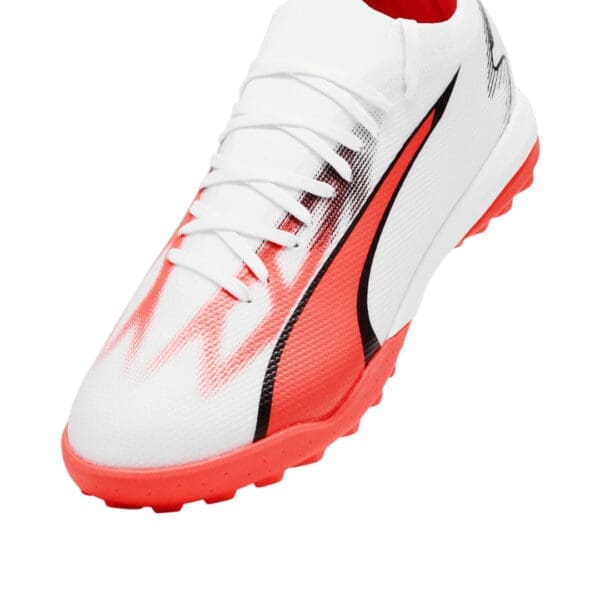 White and red Puma soccer cleat.