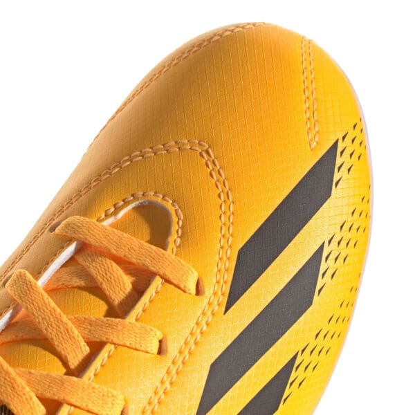 Yellow soccer shoe with black stripes.