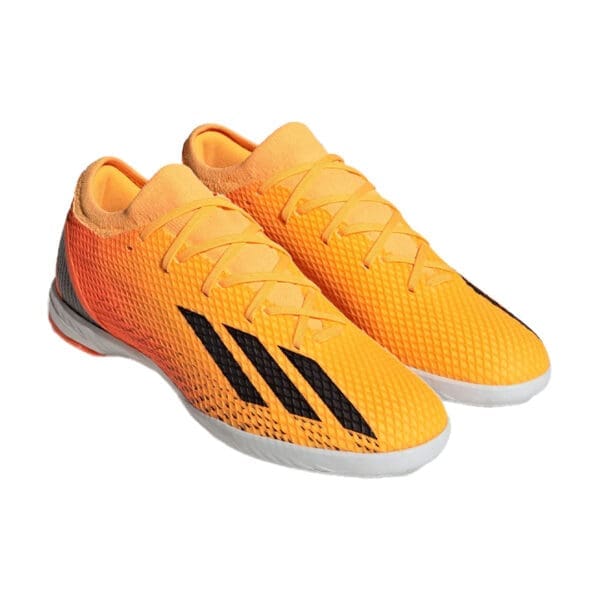 Orange and black Adidas indoor soccer shoes.