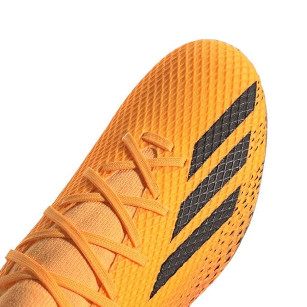 Close-up of orange Adidas soccer cleat.