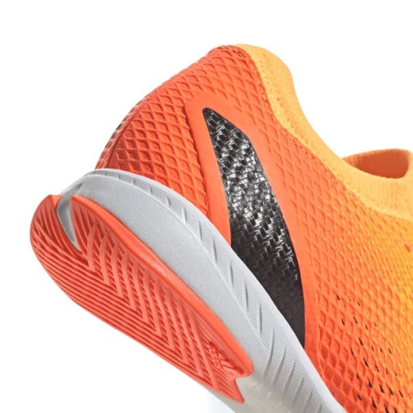 Orange and black athletic shoe sole.