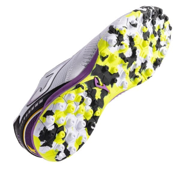 White soccer shoe with yellow and black sole.