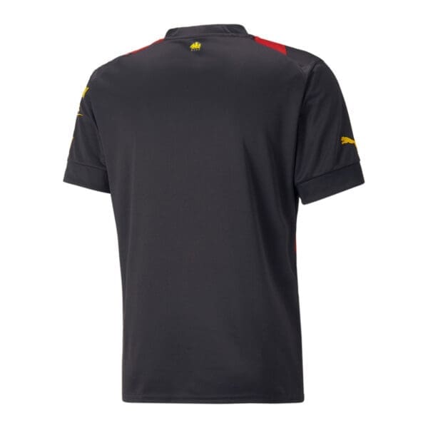 Black Puma soccer jersey with red accents.