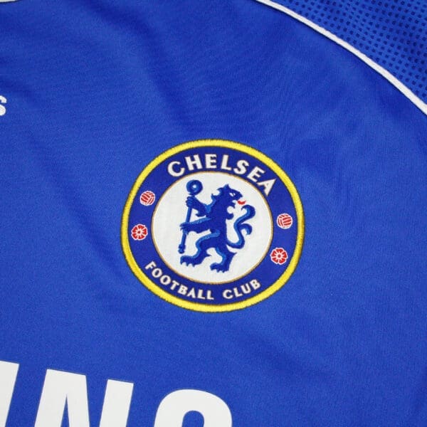 Chelsea Football Club logo on blue jersey.