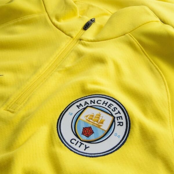 Manchester City yellow quarter-zip jacket.