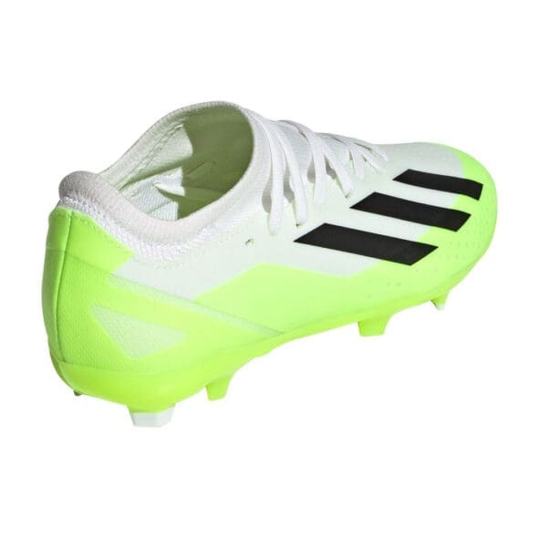 White and neon green Adidas soccer cleats.