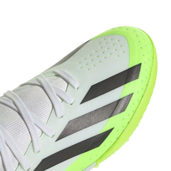 White and green Adidas soccer shoe.