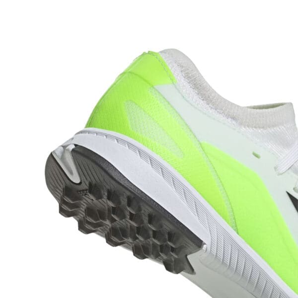 White and neon green running shoe sole.