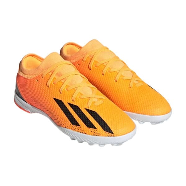 Orange Adidas soccer cleats with black stripes.