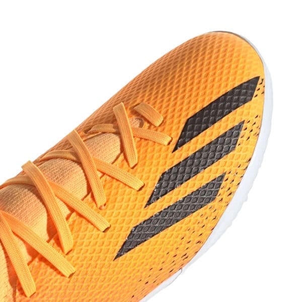 Orange and black Adidas soccer shoe.