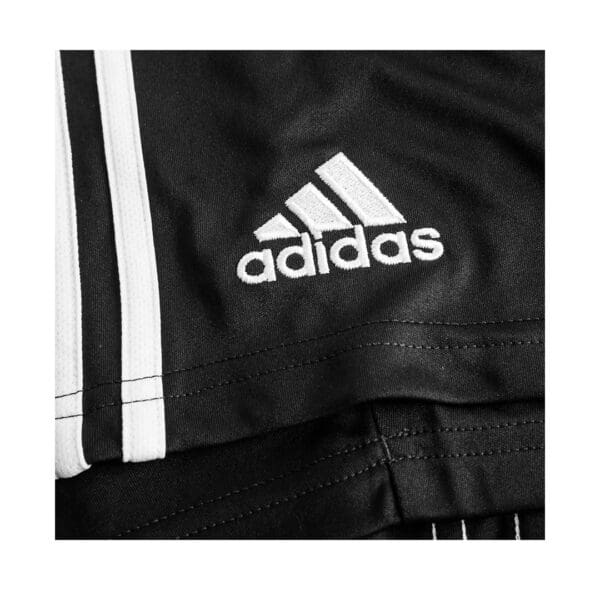 Black Adidas shorts with white stripes.