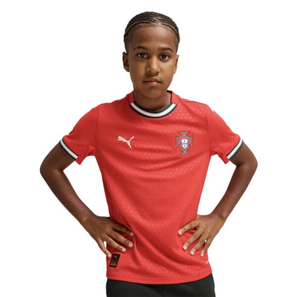 Boy modeling Portugal Puma soccer jersey.