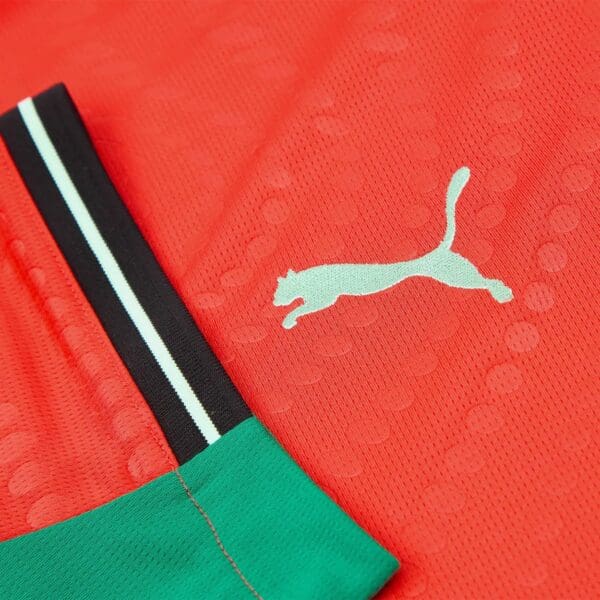 Red Puma jersey detail close-up.