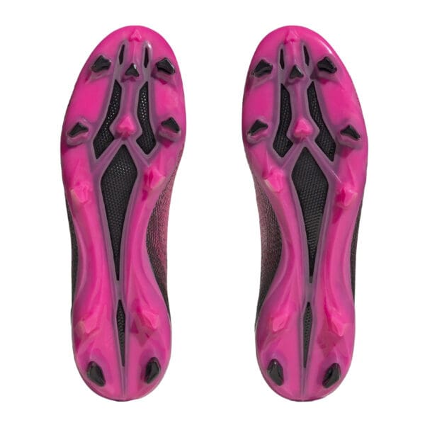 Pink and black soccer cleats bottoms.