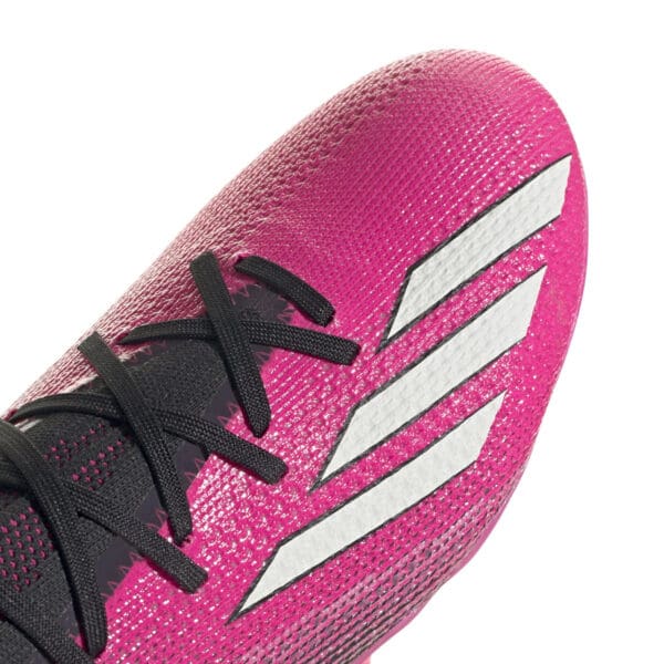 Pink Adidas soccer cleat close-up.